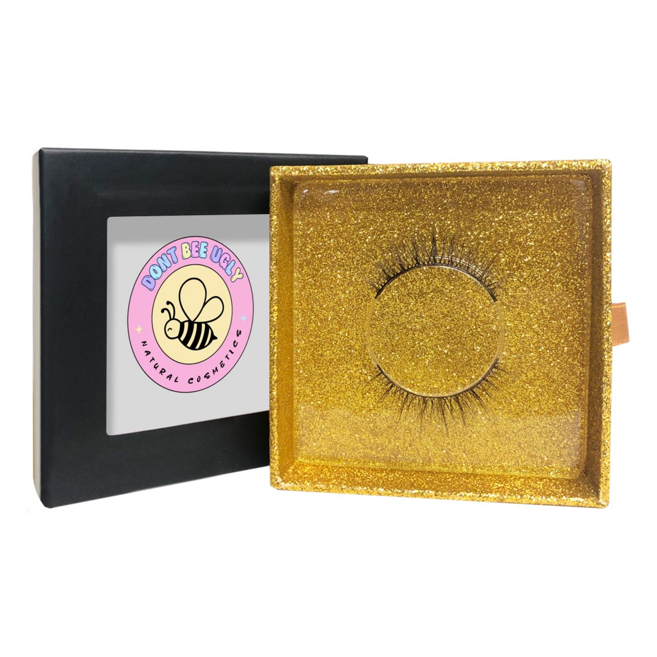 Gold glittery box with false eyelashes and a visible brand logo on a white background